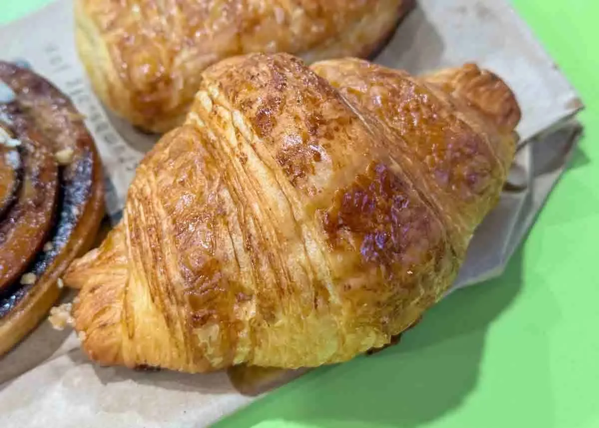 A Petite Krumbs butter croissant, deeply laminated and glazed
